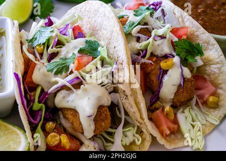 Fried fish tacos on soft flour tortilla. Extreme close up. Stock Photo