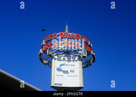 Cardiff Bay-Red Dragon Radio sign against blue sky  Taken March 2023 Stock Photo