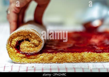 Woman rolling a jelly roll by hand. Close up Stock Photo