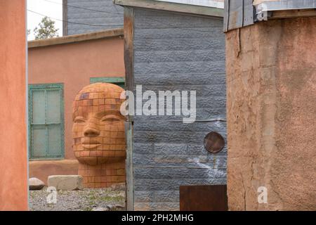 A large sculpture of a human head found in an alleyway in Santa Fe New Mexico Stock Photo