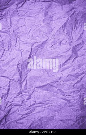 Top view of wrinkled textured paper. Purple crumpled paper texture background. Wrinkled, abstract paper background. Vertical banner. Stock Photo