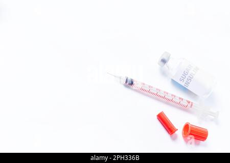 Medical syringe and sugar insulin for diabetes on white background. Top view. Stock Photo