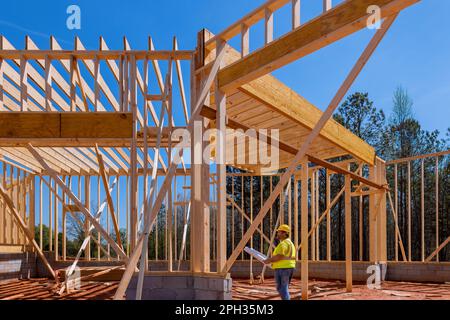 During construction process on construction site builder contractor is using architectural blueprint plan Stock Photo
