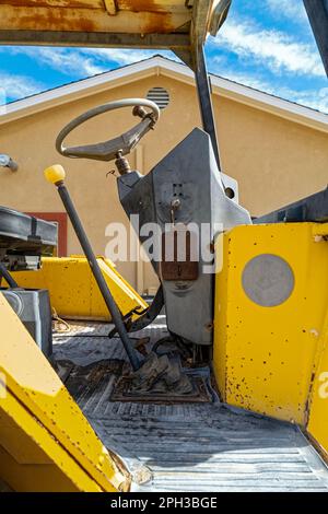 The cab of a backhoe parked with the keys in the ignition Stock Photo