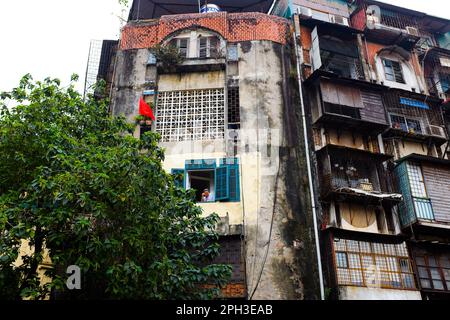 A man looks out of a window in Hanoi, Vietnam, in 2023. Stock Photo
