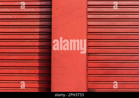 texture pattern of iron door of closed store and rough wall in Brazil Stock Photo