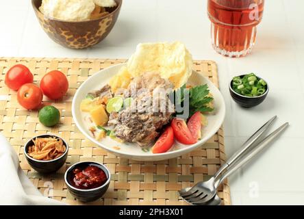 Soto Betawi Iga, Traditional Beef Ribs Soup from Betawi, Jakarta. Indonesia Traditional Soup made from Cow and Coconut Milk, Contain of Potato, Tomato Stock Photo
