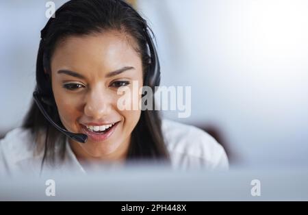 Strive to exceed customers expectations. a female agent working in a call centre. Stock Photo