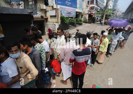 Bangladesh Trading Corporation sells necessary food products at subsidised prices. People crowd a TCB shop to buy goods early morning. Stock Photo