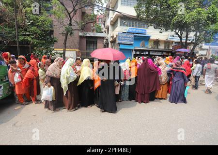 Bangladesh Trading Corporation sells necessary food products at subsidised prices. People crowd a TCB shop to buy goods early morning. Stock Photo