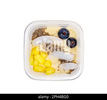 Smoothies with fresh fruits and nuts. Pineapple puree, banana. Pieces of coconut with blueberries. High quality photo. View from above. Stock Photo