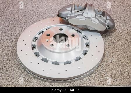 steel brake disc and Gray lie on the table in the workshop Stock Photo