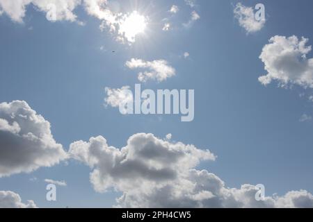 dark storm clouds illuminated by the rays of the sun Stock Photo