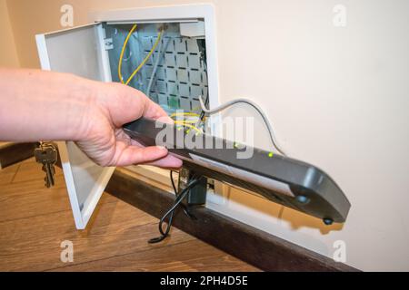 Open box to router, human hand human hand is holding black router Stock Photo