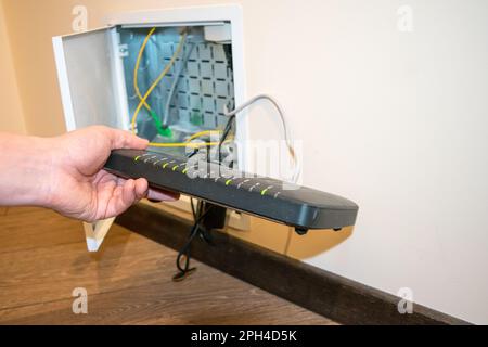 Open box to router, human hand human hand is holding black router Stock Photo