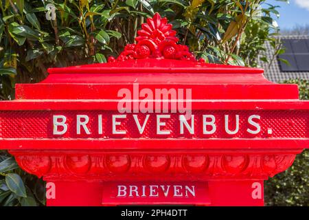 Retro style red mail box in historic village Orvelte, Netherlands Stock Photo
