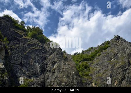 Tranquil scenic view of majestic rocky mountains against cloudy sky. Copy space. Selective focus. Stock Photo