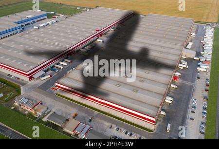 Shadow of airplane on a logistic center. World trade and transportation concept Stock Photo