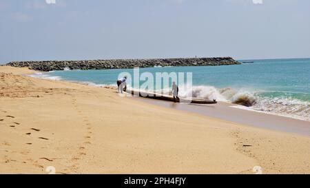 Kanyakumari,Tamilnadu,India- December 28 2021: Tamilnadu fishermen getting their wooden boat or catamaran for fishing in Bay of Bengal. Stock Photo