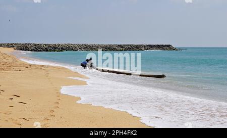 Kanyakumari,Tamilnadu,India- December 28 2021: Tamilnadu fishermen getting their wooden boat or catamaran for fishing in Bay of Bengal. Stock Photo