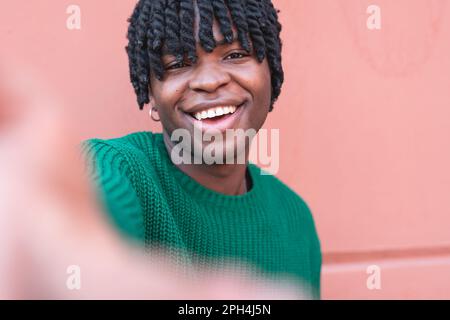Happy african american young man taking selfie and enjoying a beautiful spring day Stock Photo