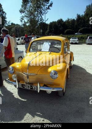 Le Bourget du lac, France - August 19th 2012 : Public exhibition of classic cars. Focus on a yellow Renault 4CV grand luxe. Stock Photo