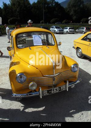 Le Bourget du lac, France - August 19th 2012 : Public exhibition of classic cars. Focus on a yellow Renault 4CV grand luxe. Stock Photo