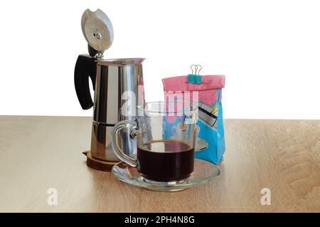 https://l450v.alamy.com/450v/2ph4n8g/opened-geyser-coffee-maker-on-table-glass-cup-with-coffee-and-opened-pack-of-coffee-with-binder-2ph4n8g.jpg
