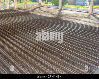 Installation of a reinforced concrete monolithic ceiling on formwork made of corrugated board, the process of laying reinforcement Stock Photo