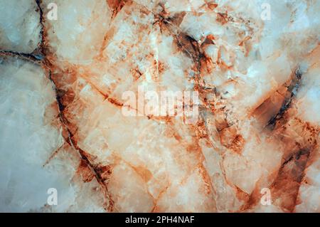 The background of a cream-colored marble slab with rusty brown streaks. Texture of natural stone. Stock Photo