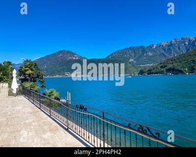 View on Lake Lugano with Mountain in a Sunny Summer Day in Morcote, Ticino, Switzerland. Stock Photo