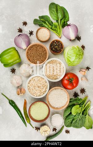 Groats and vegetables on a light table. Healthy eating Great food. Vegetarian food. Food background. Stock Photo