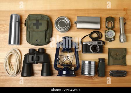 Set of traveler's equipment on wooden table, flat lay Stock Photo