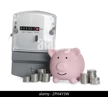 Electricity meter, piggy bank and stacked coins on white background Stock Photo