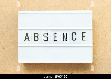 Lightbox with word absence on wood background Stock Photo
