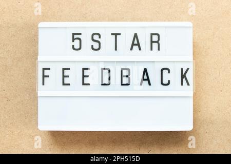 Lightbox with word 5 star feedback on wood background Stock Photo