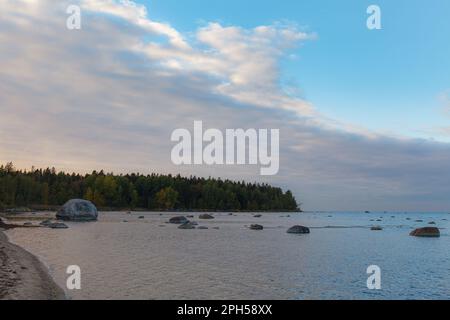 Boulders on the shore of the Baltic sea. Cloudy sunset. Stock Photo