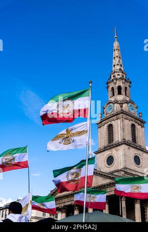 Old Iran Flags waving at Trafalgar Square in Iranian  pro-democracy protest against the autocratic Islamist government of Iran, London, England, UK 25 Stock Photo