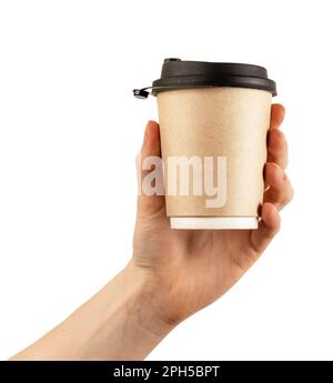 Hand holding takeaway cup mockup, cardboard paper takeout coffee mug with black lid isolated on white. Stock Photo