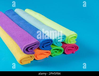 Stack of kitchen microfiber towels in bright colors on a blue background Stock Photo