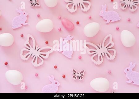 Easter eggs butterflies confetti on pink background monochromeon. Pattern. Top view. Happy Easter concept. Flat lay Stock Photo