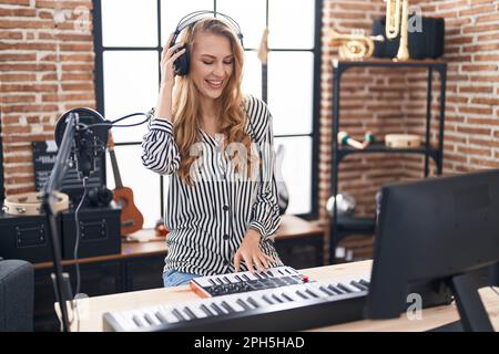 young-blonde-woman-dj-playing-piano-keyb