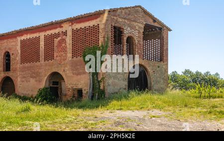 Baked brick half-timbered barn on farms in Tuscany region, near Gambassi Terme, Firenze province,central Italy with window made of herringbone tiles f Stock Photo