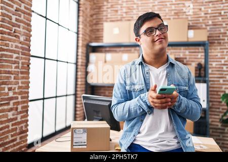 Down syndrome man ecommerce business worker using smartphone at office Stock Photo