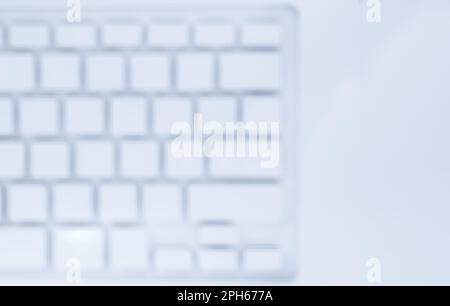 Blurred abstract background of white clean keyboard laptop computer with copy space, top view. Defocused of notebook computer keys and buttons backgro Stock Photo