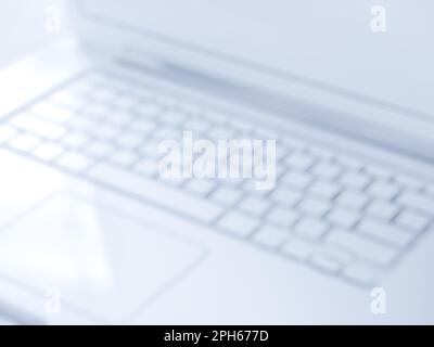 Blurred abstract background of white clean keyboard laptop computer, minimal style. Defocused of notebook keys buttons, touchpad and empty blank scree Stock Photo