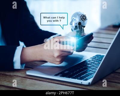 Artificial intelligence, AI chat bot technology concept. Virtual humanoid robot head with speech bubble appear on phone in person hands, smart applica Stock Photo