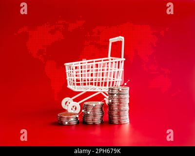 Online shopping sale profit, sales increase, business marketing, inflation concepts. Growth line graph on coin stack as a step near white shopping car Stock Photo