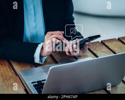 Silent mode concept. Silent or mute sound icon turn activated on appear in speech bubble on mobile smart phone in hand while business person work with Stock Photo