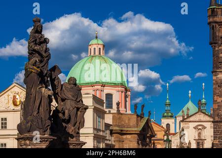 Prague old historical center beautiful 17th and 18th century baroque art and architecture. Charles Bridge statues, St. Salvator Church bell towers wit Stock Photo